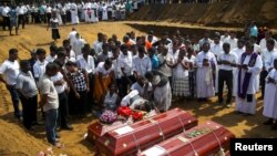 People react during a mass burial of victims, two days after a string of suicide bomb attacks on churches and luxury hotels across the island on Easter Sunday, at a cemetery near St. Sebastian Church in Negombo, Sri Lanka, April 23, 2019.