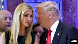 FILE - US President-elect Donald Trump talks to his daughter Ivanka during a press conference at Trump Tower in New York. 