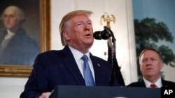 President Donald Trump, accompanied by Secretary of State Mike Pompeo, speaks in the Diplomatic Room of the White House in Washington, Oct. 23, 2019. 