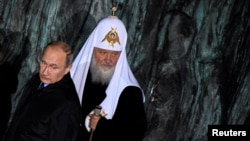 FILE - Russian President Vladimir Putin and Patriarch Kirill, the head of the Russian Orthodox Church, attend a ceremony unveiling the country's first national memorial to victims of Soviet-era political repressions called "The Wall of Grief" in Moscow.