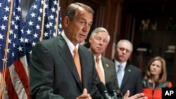 House Speaker John Boehner of Ohio, left, speaks during a news conference on Capitol Hill in Washington, Sept. 9, 2014. 