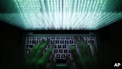 FILE - Two Iranians have been charged in an alleged scheme to steal and resell software to Iran.