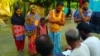 Osman Goni, with his wife and two children, showing some villagers the copies of some of the documents he had submitted to the authorities last year, seeking inclusion to the NRC of all members of his extended family, Aug. 2, 2018. When the NRC draft was 