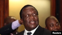 FILE - Zimbabwean Deputy President Emmerson Mnangagwa smiles at the headquarters of ZANU (PF) in Harare, Dec.10, 2014. 