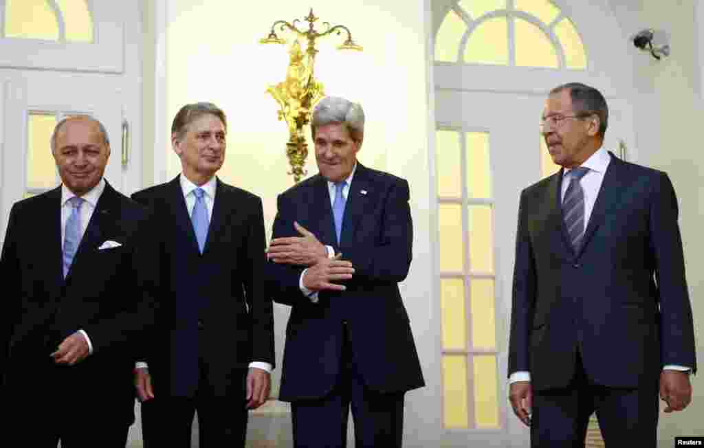 French Foreign Minister Laurent Fabius, Britain's Foreign Secretary Philip Hammond, U.S. Secretary of State John Kerry and Russian Foreign Minister Sergei Lavrov pose for photographers before a meeting in Vienna, Nov. 24, 2014.