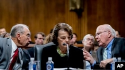 FILE - Senate Judiciary Committee Chairman Chuck Grassley, R-Iowa, left, accompanied by Sen. Dianne Feinstein, D-Calif., the ranking member, center, speaks with Sen. Patrick Leahy, D-Vt., right, during a Senate Judiciary Committee markup meeting on Capitol Hill, Sept. 13, 2018.