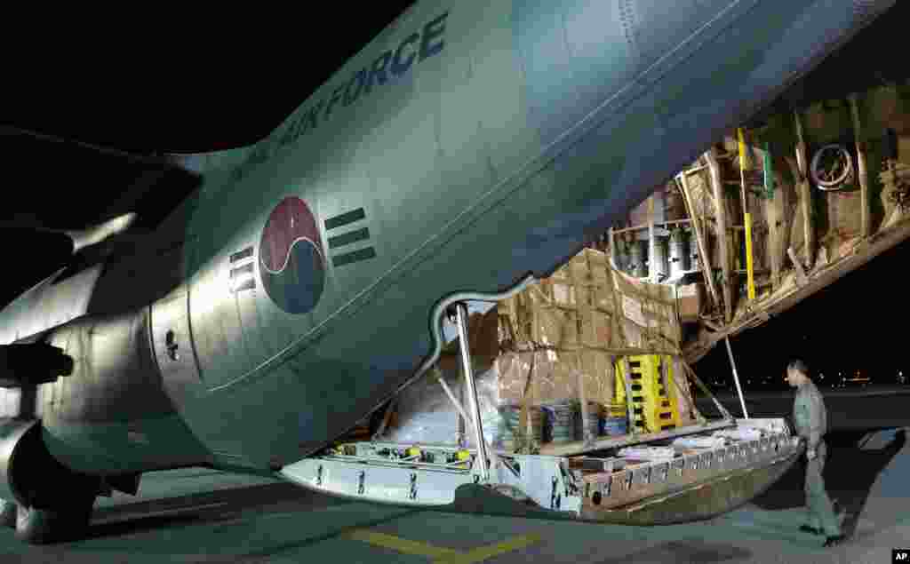 A South Korean soldier checks relief goods on South Korean Air Force cargo plane C-130 before it leaves for Tacloban airport, Philippines for victims of Typhoon Haiyan, at Seoul military airport in Seongnam, South Korea, Nov. 14, 2013.