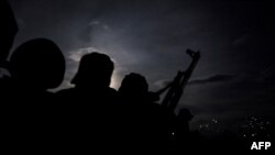 FILE - Local police accompanied by government forces patrol in the Democratic Republic of Congo, May 18, 2019.