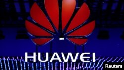 FILE - The Huawei logo is seen during the Mobile World Congress in Barcelona, Spain, Feb. 26, 2018.