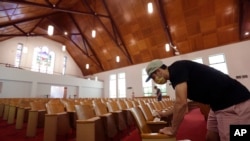 Alamo Heights Baptist Church pastor Bobby Contreras, right, works to clean, sanitize and prepare his church for services this Sunday, in San Antonio, May 6, 2020.