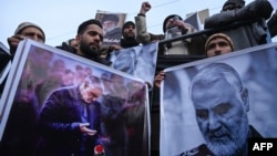 Protesters hold posters with the image of top Iranian commander Qasem Soleimani, who was killed in a US airstrike in Iraq, during a demonstration in the Kashmiri town of Magam on January 3, 2020. (Photo by Tauseef MUSTAFA / AFP)