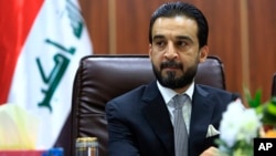 FILE - Iraqi Parliament Speaker Mohammed al-Halbousi meets with Basra provincial Council members in Basra, Iraq, Sept. 18, 2018.