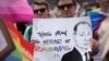 FILE - Participants in the Brooklyn Pride Parade hold a sign that reads, "Putin is afraid of rainbows," May 19, 2024.