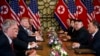 FILE - President Donald Trump speaks during a meeting with North Korean leader Kim Jong Un, in Hanoi, Vietnam, Feb. 28, 2019. At left is then-National Security Adviser John Bolton.