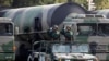 FILE PHOTO: PLA soldiers salute in front of nuclear-capable missiles during a parade in Beijing.