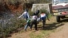 Myanmar Red Cross members carry injured victim during clash between government troops and Kokang rebels in northeastern Shan State, northeast of Yangon, Feb. 17, 2015.