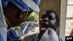 A medical officer takes a sample for a COVID-19 test at the laboratory of Kenya Medical Research Institute, which has the capacity to test 384 samples per day, in Kisumu, Kenya, on April 23, 2020.
