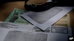 FILE - A stimulus check issued by the Internal Revenue Service to help combat the adverse economic effects of the coronavirus pandemic is seen in San Antonio, Texas, April 23, 2020. 