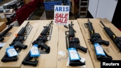 FILE - AR-15 rifles are displayed for sale at a gun show in Pennsylvania, Oct. 6, 2017. 