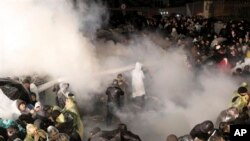 Riot police use tear gas and water cannons against people gathered in support of Turkey's largest-circulation newspaper Zaman at its headquarters in Istanbul, early Saturday, March 5, 2016. The police raid came hours after a court placed it under the management of trustees on Friday. The move against the paper, which is linked to an opposition cleric, heightened concerns over deteriorating press freedoms in the country. 