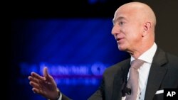 FILE- In this Sept. 13, 2018, file photo Jeff Bezos, Amazon founder and CEO, speaks at The Economic Club of Washington's Milestone Celebration in Washington. 