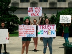 FILE - Abortion rights supporters protest at the Louisiana Capitol, where lawmakers were considering a bill that would ban abortion as early as six weeks of pregnancy, May 21, 2019, in Baton Rouge, La. The bill won final passage May 29.