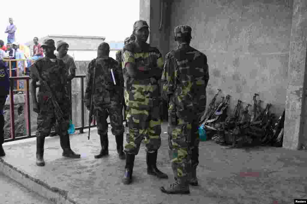 M23 rebels guard weapons given to them by the government&#39;s army, Goma, DRC, November 21, 2012. 