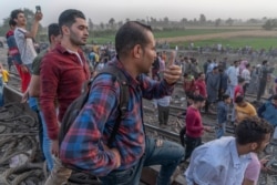 Onlookers are seen at the site of Sunday's train crash north of Cairo. In March, another rail accident killed at least 20 people and injured 200 about 275 kilometers south of Cairo. (Hamada Elrasam/VOA)