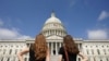 Women gaze at the dome of the US Capitol, days after the removal of security fencing which was placed around the complex after the Jan. 6 attack, in Washington, July 12, 2021. 