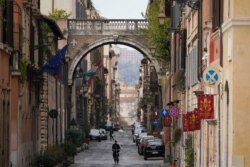 A view of an empty street, in Rome, March 21, 2020. Mayors of many towns in Italy are asking for ever more stringent measures on citizens' movements to help contain the surging infections of the coronavirus.