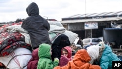 Civilians flee from Idlib toward the north to find safety inside Syria near the border with Turkey, Feb. 15, 2020. Syrian troops are waging an offensive in the last rebel stronghold.