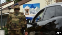 Soldiers stand at the entry of the 5th RHC (Fighter Helicopter Regiment) base, the regiment 7 of the soldiers killed in the helicopter crash in Mali belong to, in Uzein near Pau, southwestern France, Nov. 26, 2019. 