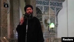 Image taken from recently released video shows man purported to be Abu Bakr al-Baghdadi, ISIL's reclusive leader, making what would be his first public appearance at a mosque in the center of Iraq's second city, Mosul July 5, 2014.
