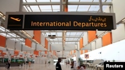 FILE - A worker walks at the departure area of the Islamabad International Airport, during a media tour.