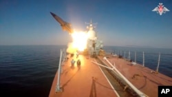 In this photo made from video provided by the Russian Defense Ministry Press Service on March 28, 2023, a Russian navy boat launches an anti-ship missile test in the Peter The Great Gulf in the Sea of Japan.