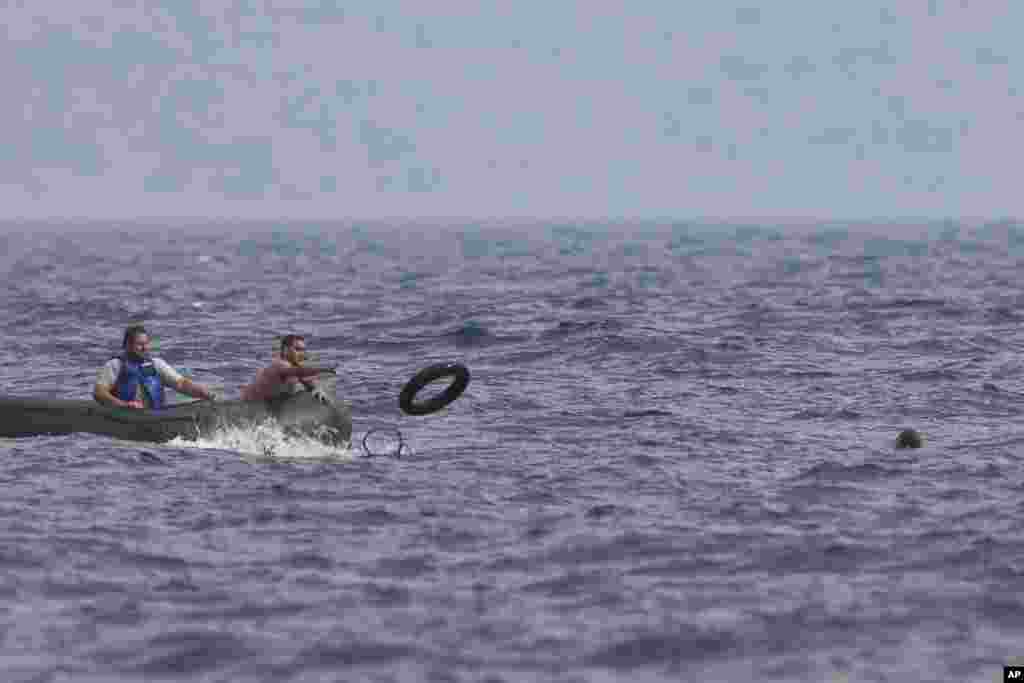 A Greek fisherman rescues a Syrian migrant, right, after his boat stalled while crossing from Turkey to the island of Lesbos, Greece, Sept. 22, 2015. More than 260,000 asylum-seekers have arrived in Greece so far this year, most reaching the country&#39;s eastern islands on flimsy rafts or boats from the nearby Turkish coast.