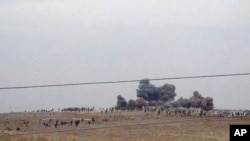 FILE - Smoke rises after airstrikes in Kafr Nabl, in Idlib province, western Syria, Oct. 1, 2015. The town was hit by airstrikes Sunday that appear to be part a region-wide Russia-backed Syrian government offensive against rebels seeking to topple the Damascus government.