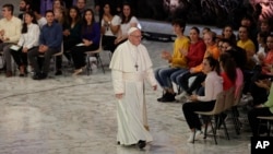 Pope Francis leaves the Paul VI hall at the end of his meeting with youths attending the Synod, at the Vatican, Oct. 6, 2018. 