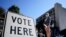 Voters stand in a line as they wait to vote early in Athens, Ga, Oct. 19, 2020. (AP)