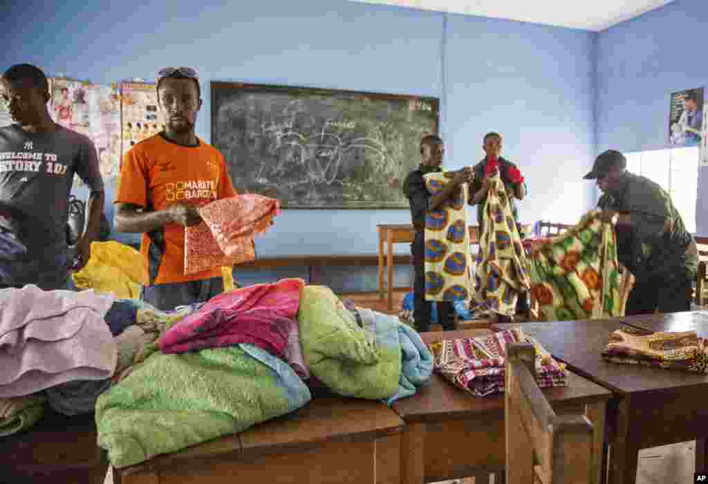 Volunteers prepare basic supplies, donated to the Ebola treatment center by American donors, at the Kenema Government Hospital in Kenema, Sierra Leone, Aug. 9, 2014.