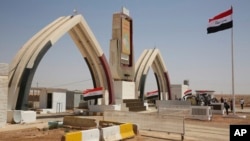 Iraqi flags fly at the recently opened Iraqi Trebil border crossing on the Iraq-Jordan border, Aug. 30, 2017.