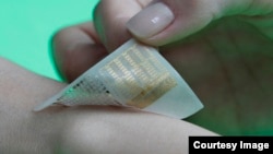 High performance multifunctional wearable electronics integrated with nanoparticles are attached to the skin for the diagnosis and therapy of motion-related neurological disorders. (Credit: Donghee Son and Jongha Lee)