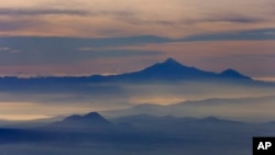 FILE - Four Mexican citizens died in a climbing accident on the Pico de Orizaba, that country's highest peak, shown in this 2013 file photo.