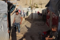 Mahmoud, father of a 4-month-old girl, says increasing poverty has made it impossible for many families to heat their homes or find enough food, in a refugee encampment in Bekkaa Valley, Lebanon, Nov. 30, 2019. (Heather Murdock/VOA)