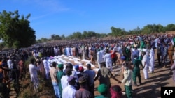 People attend a funeral for those killed by suspected Boko Haram militants in Zaabarmar, Nigeria, Nov. 29, 2020. 