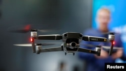 FILE - A DJI Mavic 2 Zoom flies in a netted area during the 2019 CES in Las Vegas, Nevada, Jan. 9, 2019.