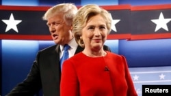 Republican U.S. presidential nominee Donald Trump and Democratic U.S. presidential nominee Hillary Clinton take the stage for their first debate in Hempstead, New York, Sept. 26, 2016. 