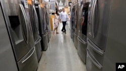 FILE - Shoppers examine refrigerators at a Home Depot store in Boston, Sept. 23, 2019. The U.S. announced May 3, 2021, that it will phase out hydrofluorocarbons found in refrigerators, freezers and air conditioners. 