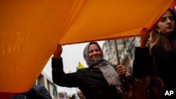 Pro-Kurdish people shout slogans as they march during a protest in Brussels against Turkey's invasion of northern Syria, Oct. 16, 2019. 