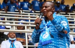 FILE - Central African Republic President Faustin Archange Touadera addresses supporters at a political rally at a stadium in Bangui, Dec. 19, 2020.